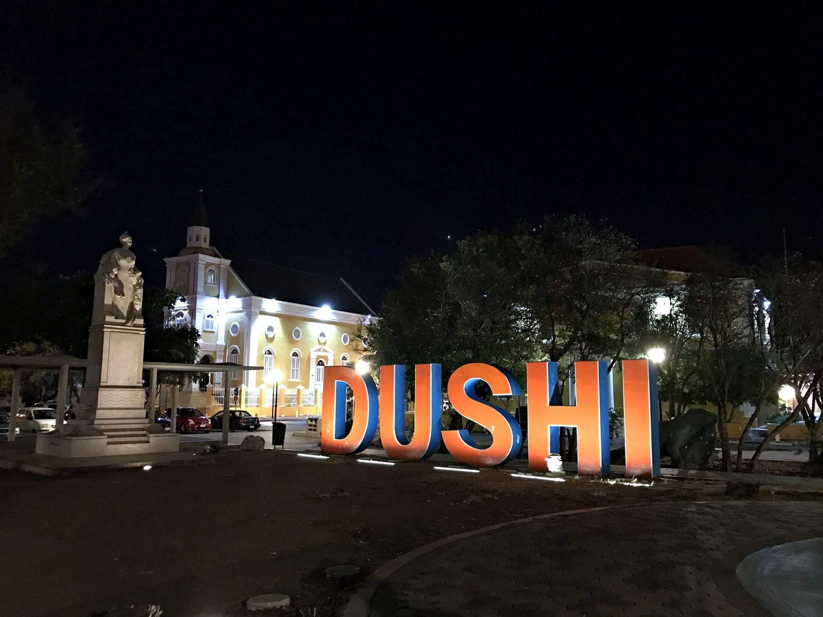 The Curaçao sign lit up at night in Willemstad