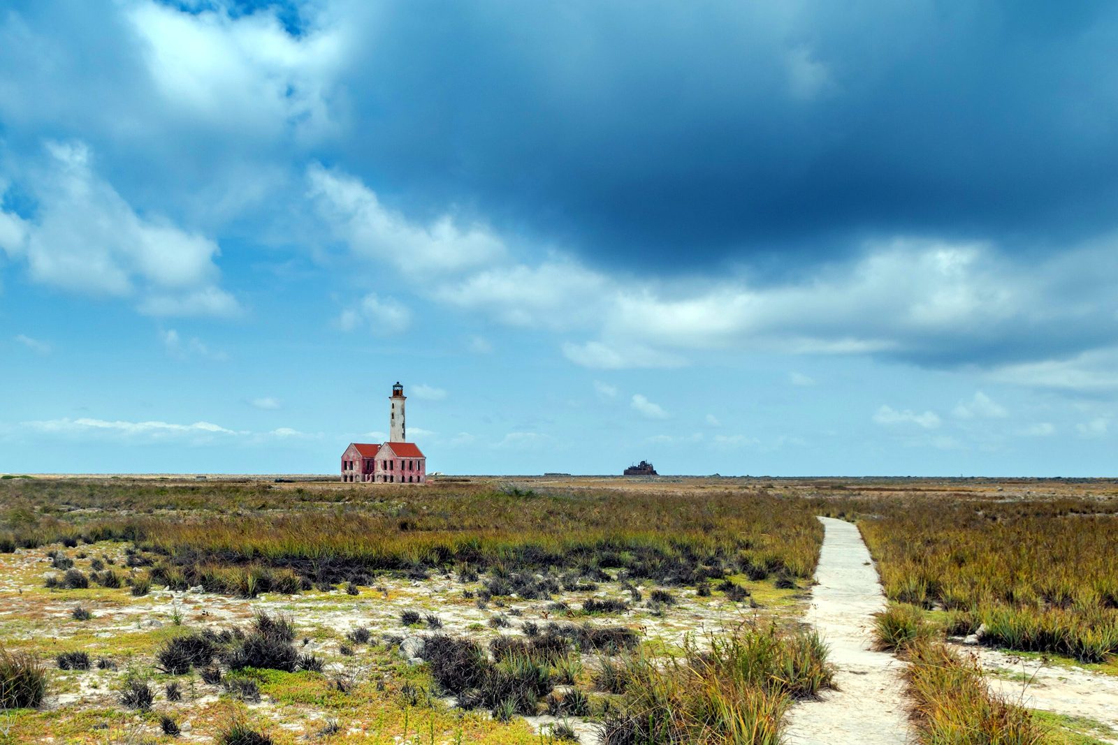 The old lighthouse on Klein Curaçao above white sand and turquoise water