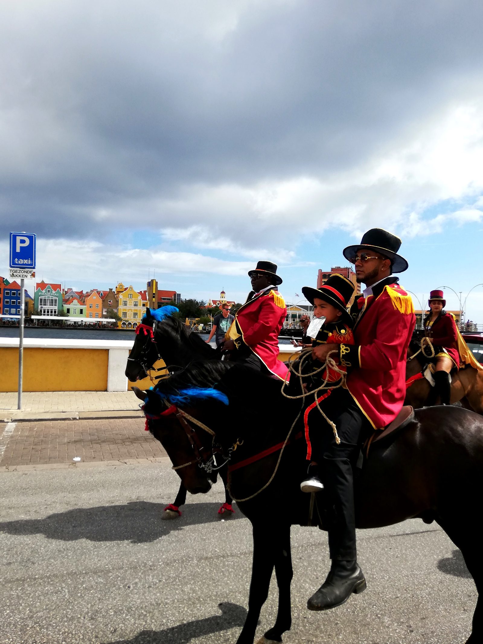 Riders in red coats at the Carnival Horse Parade in Otrobanda