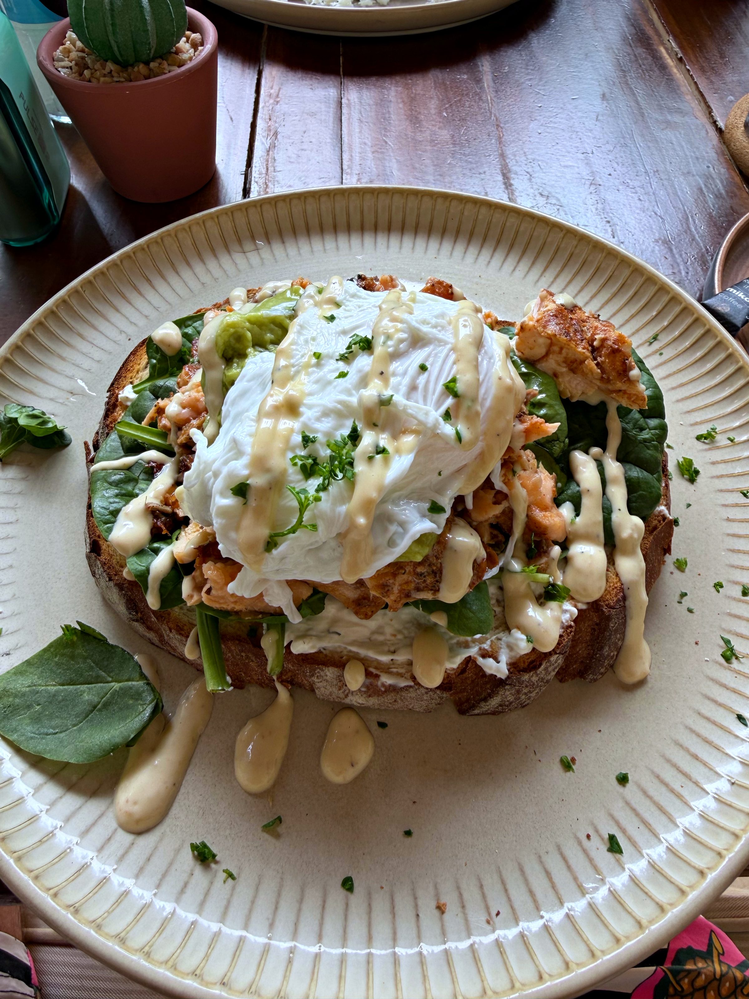 Salmon and egg toast on a white plate at Downtown by 5999