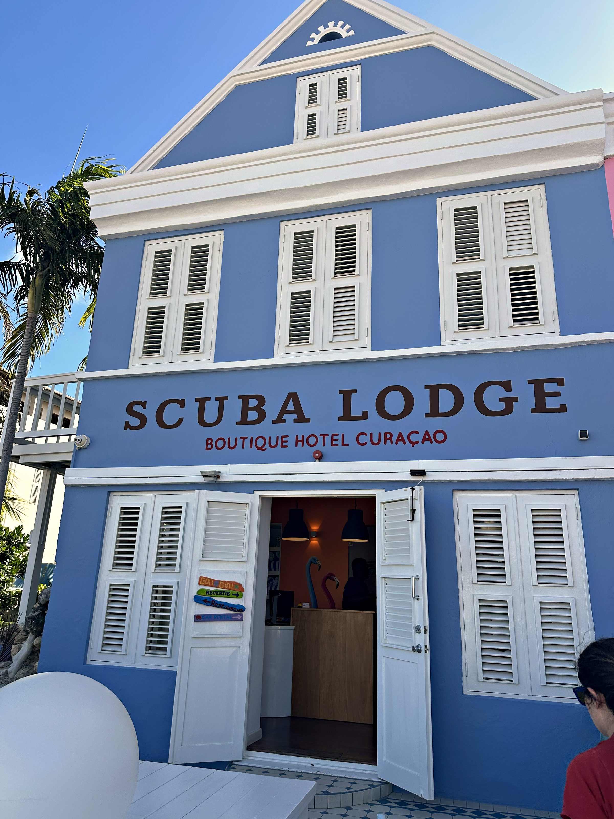 The blue facade and sign of Scuba Lodge in Curaçao
